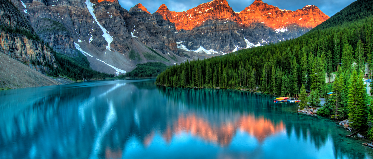 Canadian mountain peaks and forest reflected in a turquoise lake